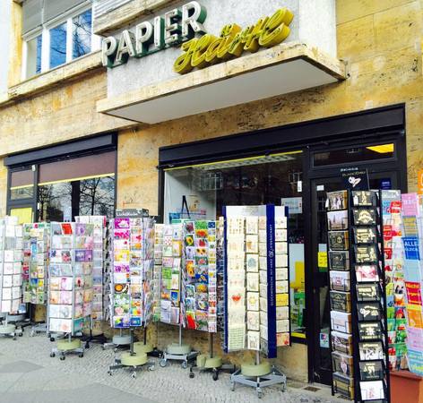 Papierwarenladen mit zahlreichen Grußkartenständern vor dem Geschäft in der Innenstadt.